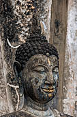 Thailand - Old Sukhothai - Wat Saphan Hin. the small statue of a seated Buddha in the  calling the Earth to witness  mudra. 